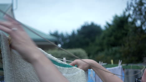 man white hanging clothes on an outdoor washing line