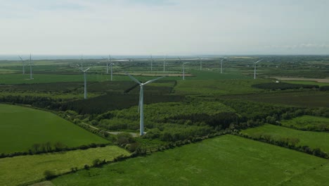 Flying-Through-Wind-Energy-Green-Fields-In-County-Wexford,-Ireland