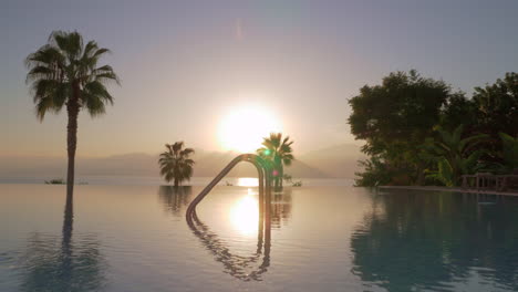 swimming pool on resort view against the sunset