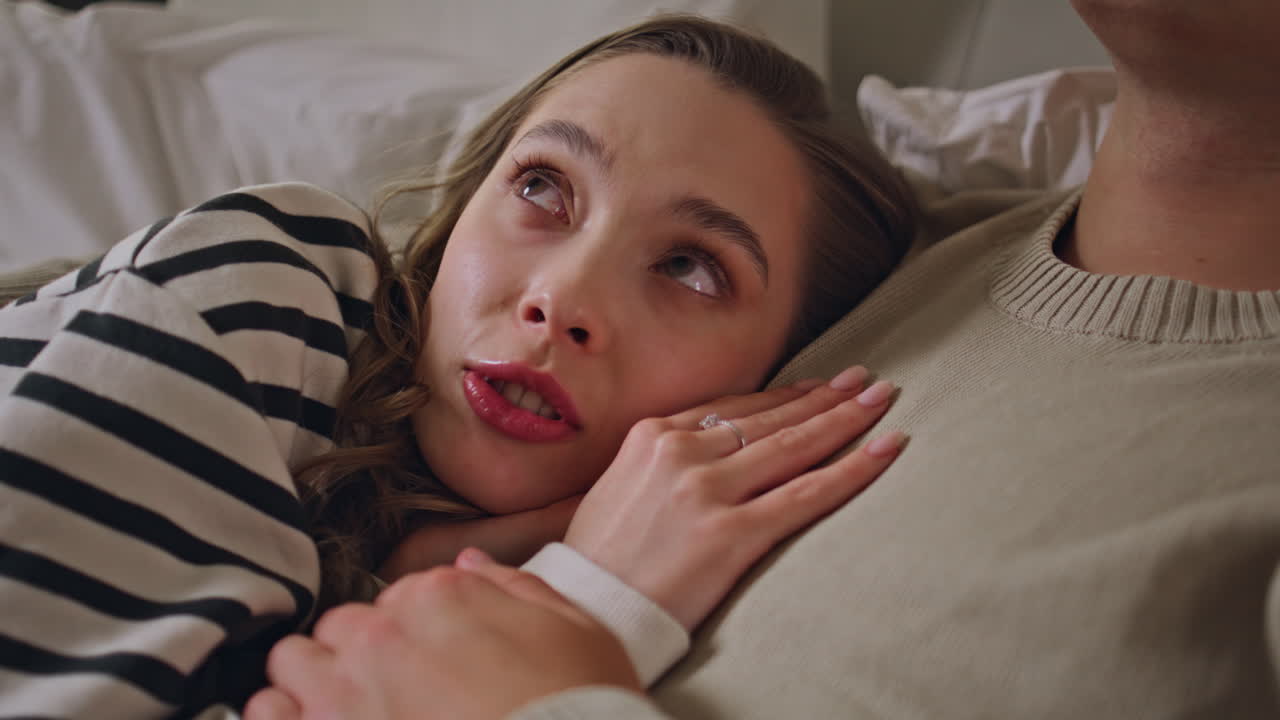 Wife lying husband chest resting together in cozy home bed closeup. Love couple