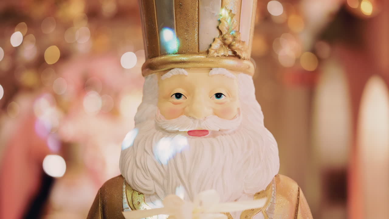 Close up of a Santa Claus figure inside a festive Christmas installation with warm lights and ornaments