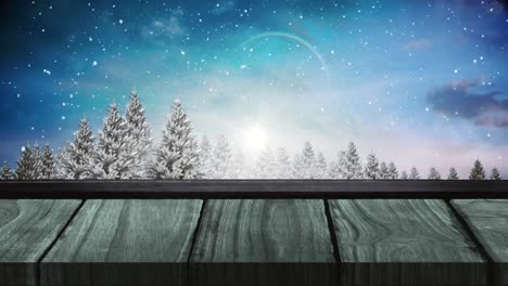 Animation-of-winter-scenery-with-snow-falling-with-wooden-surface-in-the-foreground