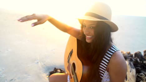 indian american girl boho sundress relaxing with guitar