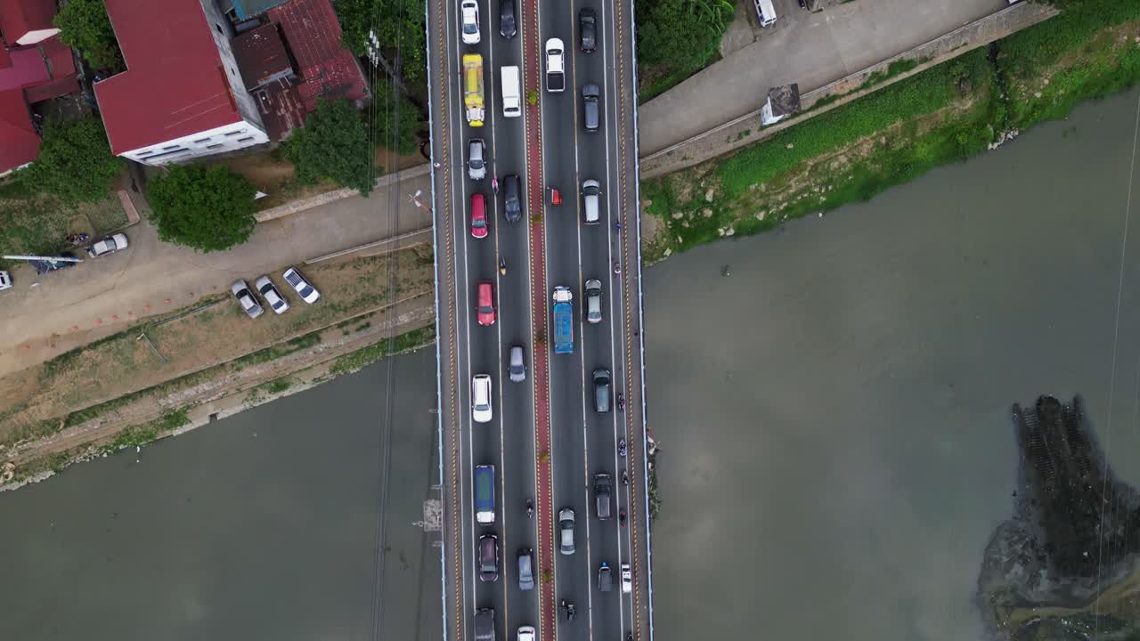 A Bridge Loaded With Driving Vehicles In Marikina City, Metro Manila, Philippines. Aerial Topdown Shot