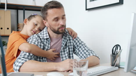 tired father working from home with daughter