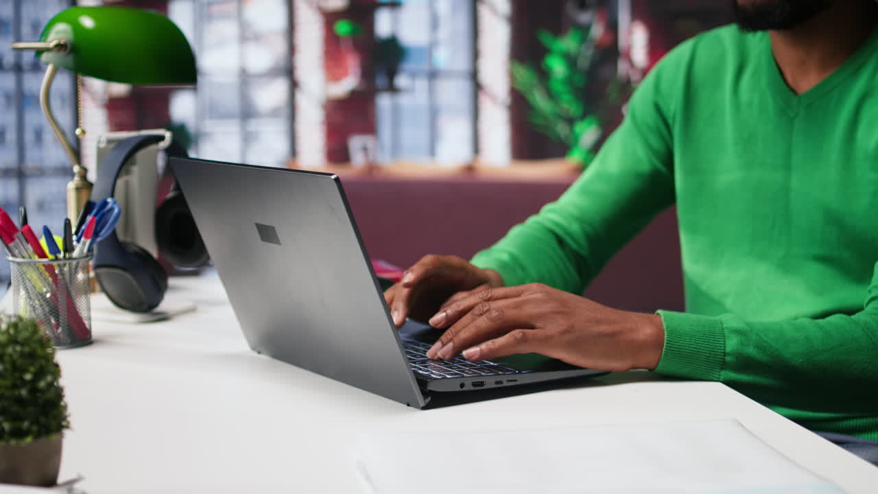 Vertical Video African american teleworker typing ideas to create a vision board on laptop