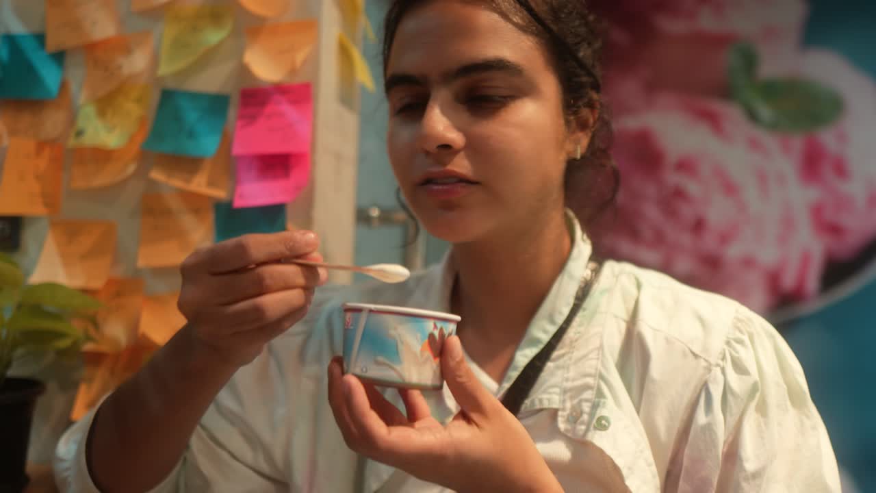 Young Woman Enjoying Ice Cream from a Cup