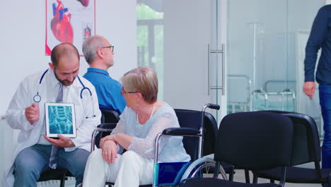 physician giving diagnosis on x ray tablet pc