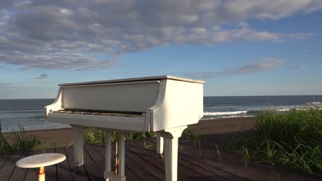 white piano on the beach