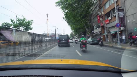 taxi driver pov drive on streets of istanbul, turkey. view from passenger seat with visible reflections on windwhield of car