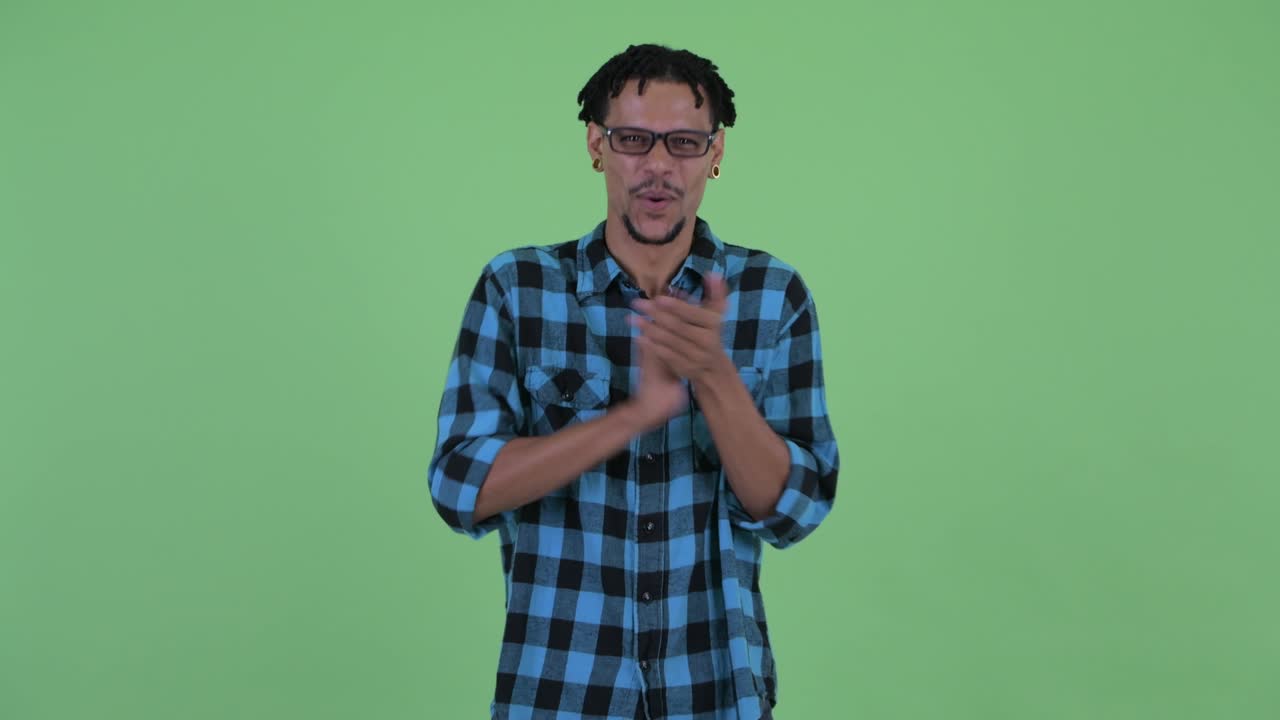 Happy young handsome African hipster man with dreadlocks