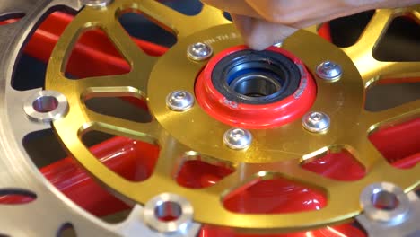 close-up footage of mechanic working on disc brake installation for motorcycle