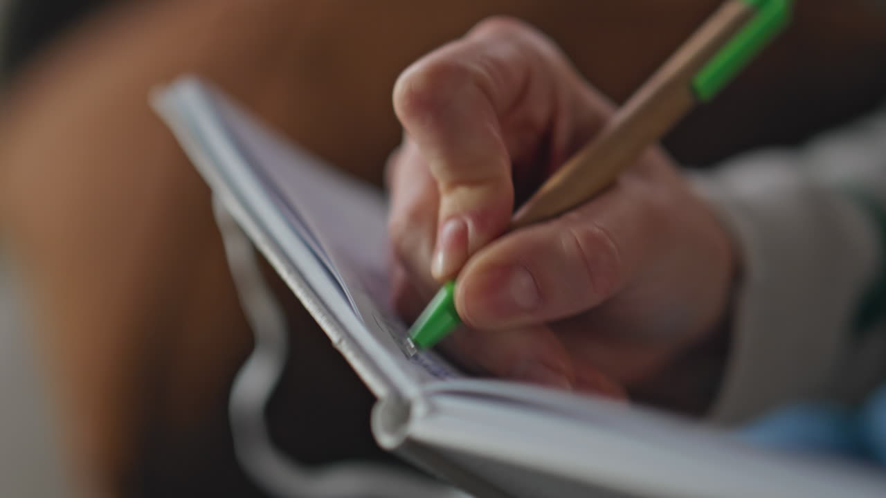 Woman hand writing copybook at home closeup. Unrecognizable girl noting thoughts