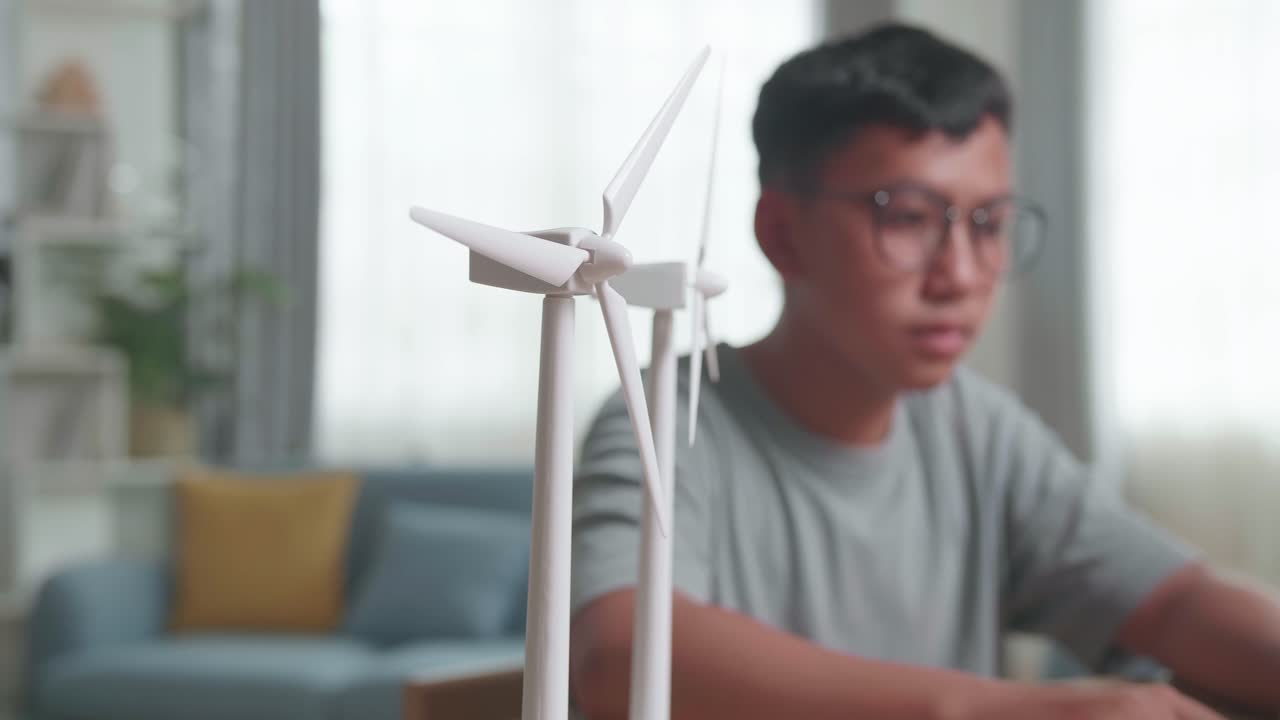 Student Studying with Wind Turbine Models