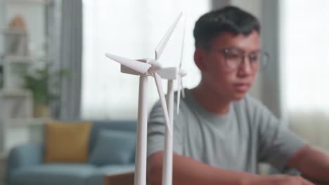 student studying with wind turbine models