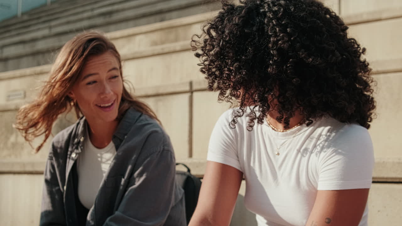 Happy guys and girls having fun talking outdoors