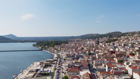 drone flying along the scenic waterfront promenade of argostoli in kefalonia island on a clear summer day
