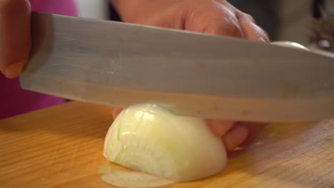 a white onion sliced on a cutting board