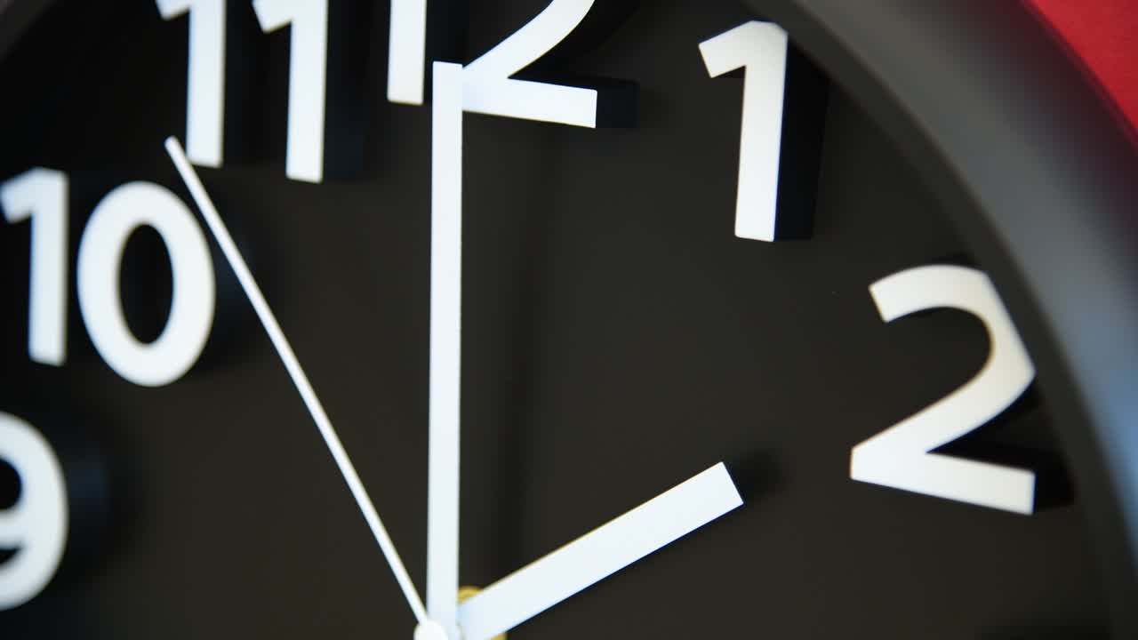 Black wall clock on red background