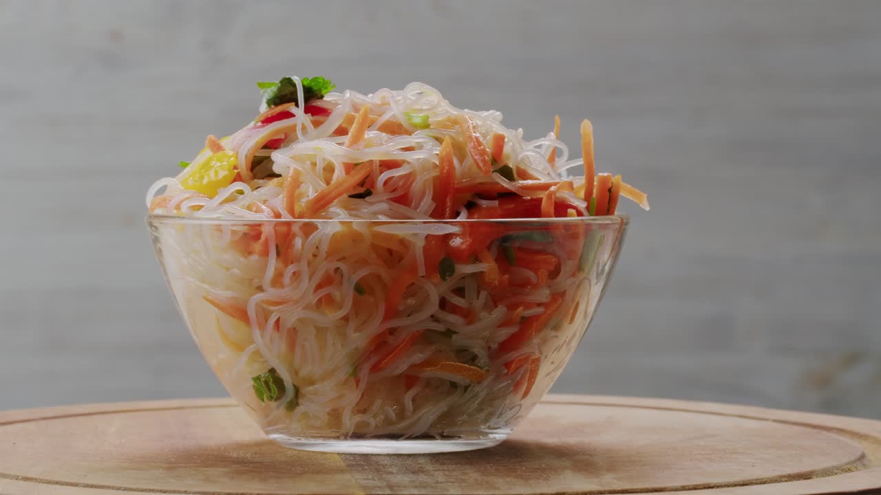 Glass noodles salad with meat and carrots fermented close up asian chinese traditional food.