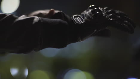 motor cycle rider wearing his gloves and flexing his hands