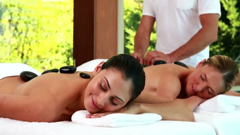 relaxed friends enjoying hot stone massages