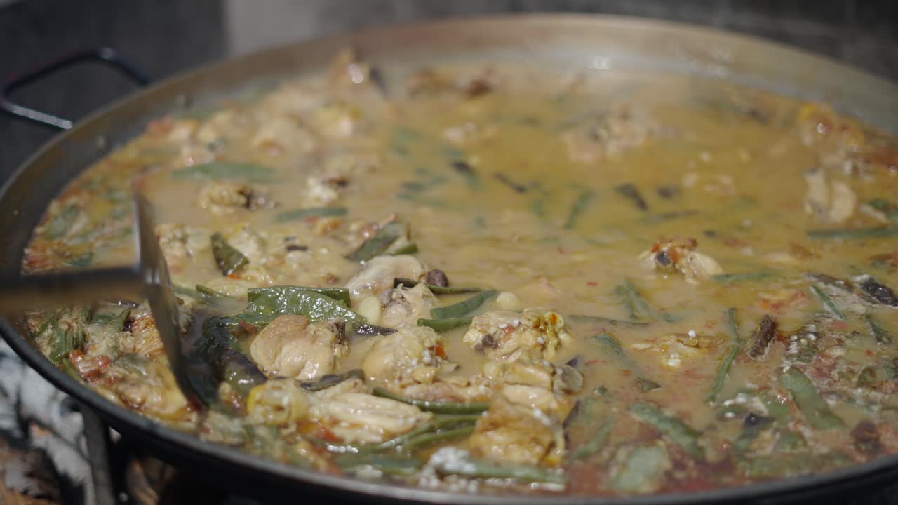 Close-up of Traditional Spanish Paella Cooking in a Large Pan