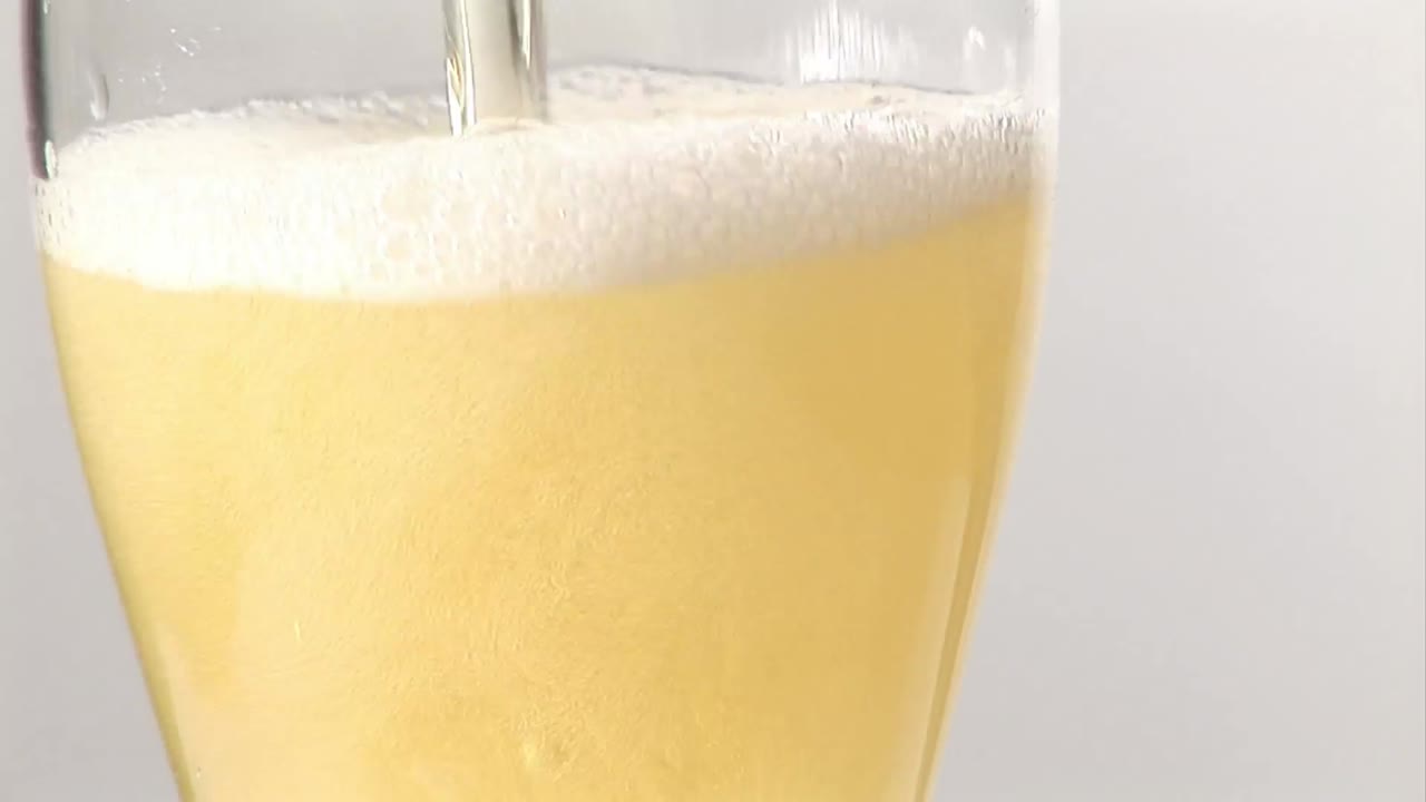 Stock Footage C.U. Pouring a pint glass of beer