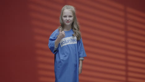 smiling girl volunteer showing thumbs up