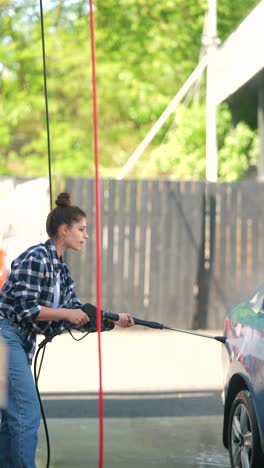 woman washing car at self-service car wash