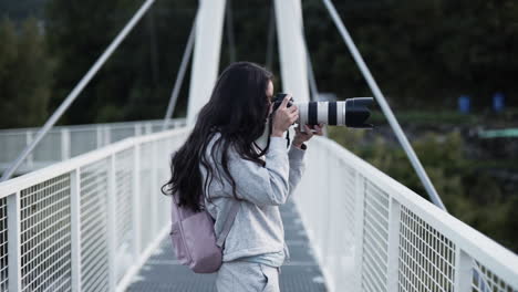 latino pro level photographer clicking with telephoto lens at huesca bridge