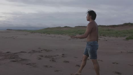 dancer backing up on the beach