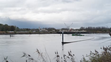 Industrial-barge-and-equipment-used-to-clean-river-water-from-trash,-time-lapse-shot