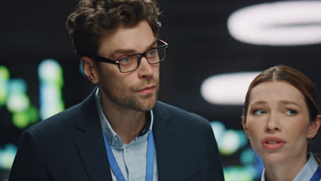 two coworkers talking datacenter closeup. developers working at server room