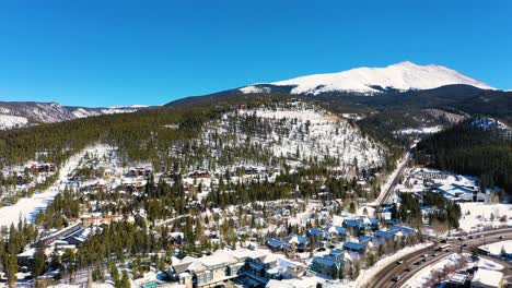 captivating drone footage from above the edge of the city into the mountainside of breckenridge, colorado