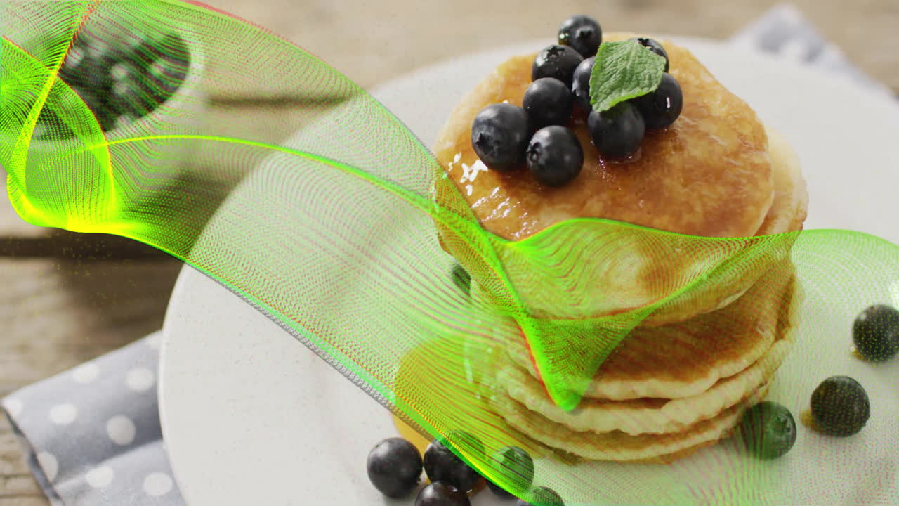 Pancakes topped with blueberries and mint, over green wave animation