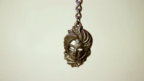 close up of the metal venetian mask souvenir keychain