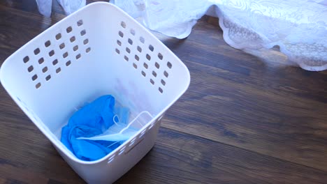 discarded gloves in a white plastic bin