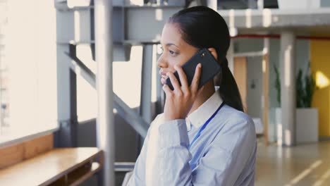 Mujer-De-Negocios-Usando-Un-Teléfono-Inteligente-En-El-Vestíbulo-De-Una-Conferencia