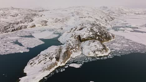 drone over landscape of snow and ice of ilulissat icefjord