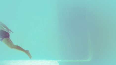 handsome man swimming underwater