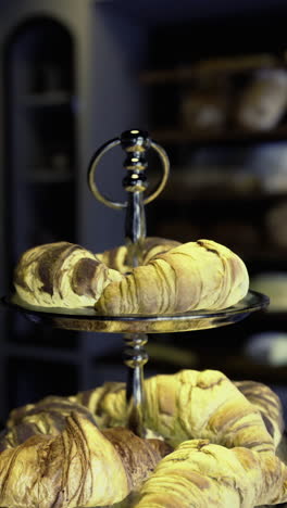 bakery display features assorted bread and pastries in a cozy setting