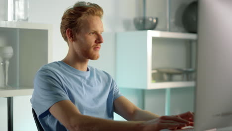 Smiling-IT-manager-typing-keyboard-at-closeup.-Ginger-man-surfing-internet-web