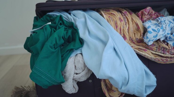 Open Suitcase Filled With Messy Clothes
