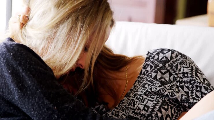 Head to head lesbian couple on sofa at home 4k