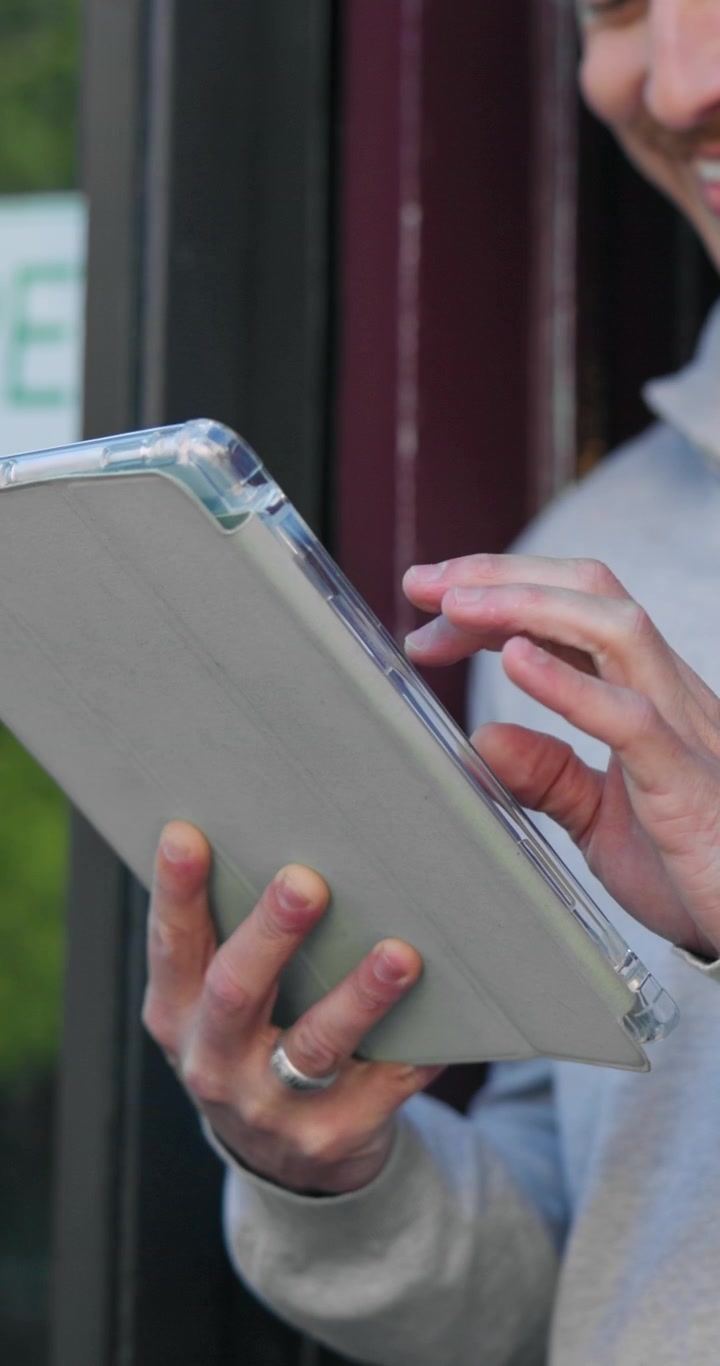 Man Using a Tablet Computer Outdoors