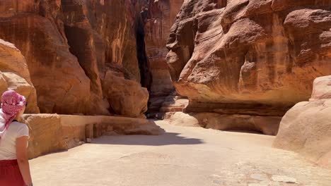 tall women walking in petra in wadi musa, close to the treasury of jordan with no other people around 4k