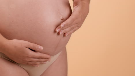 pregnant woman touching her belly