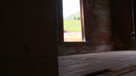 a traveling shot moves into an abandoned house in a ghost town 1