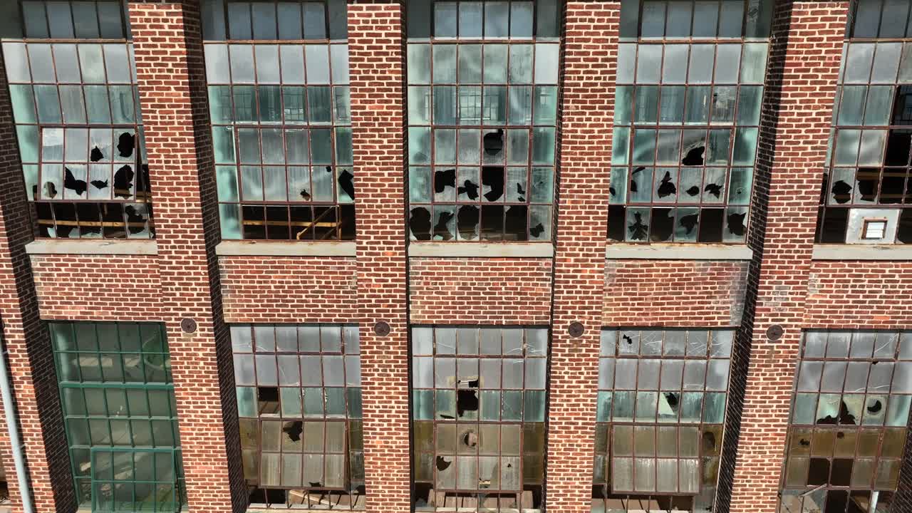 ventanas de vidrio rotas en un edificio de ladrillo abandonado
